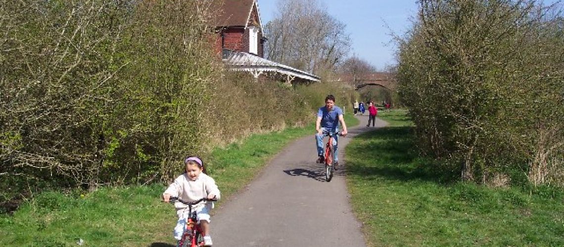 Parent and Child riding bikes on Cuckoo Trail Footpath